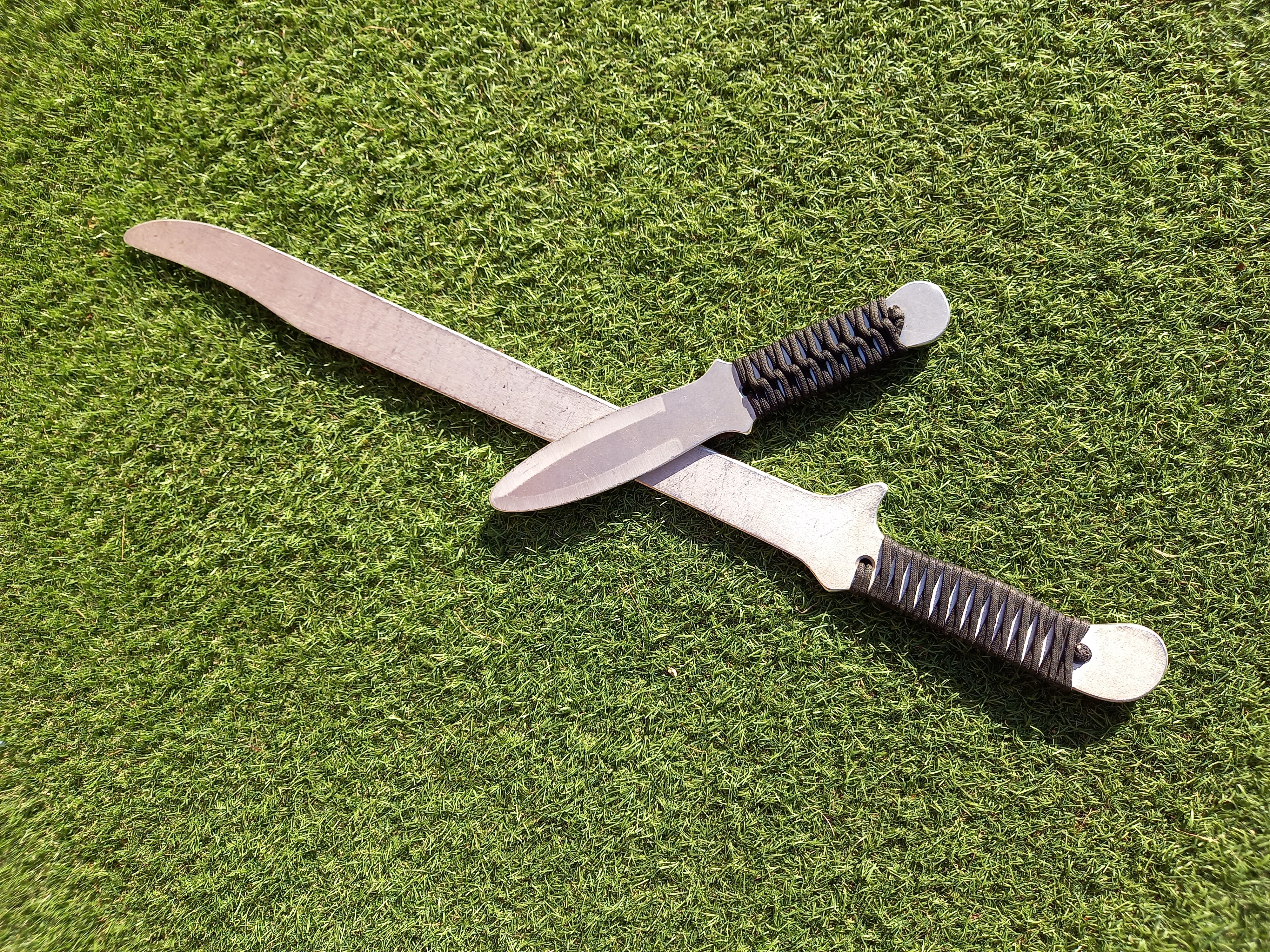 Training sword and dagger, espada y daga, on grass